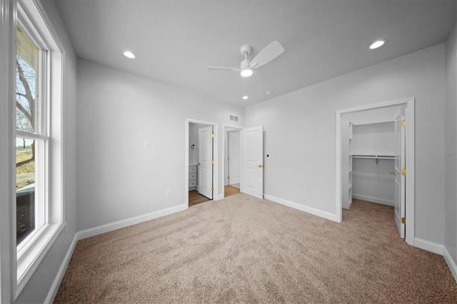 unfurnished bedroom with visible vents, baseboards, recessed lighting, a spacious closet, and carpet flooring