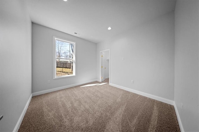 empty room featuring visible vents, recessed lighting, carpet, and baseboards