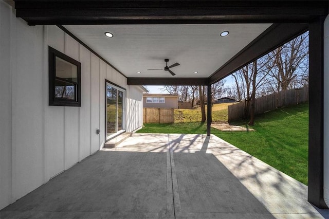 view of patio with ceiling fan and fence