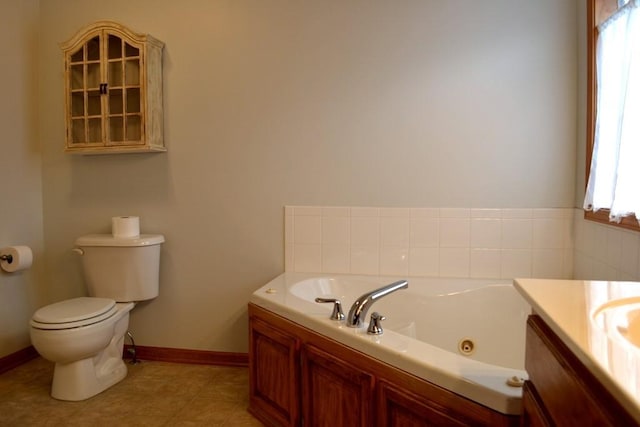 bathroom featuring a bathing tub, vanity, tile patterned floors, and toilet