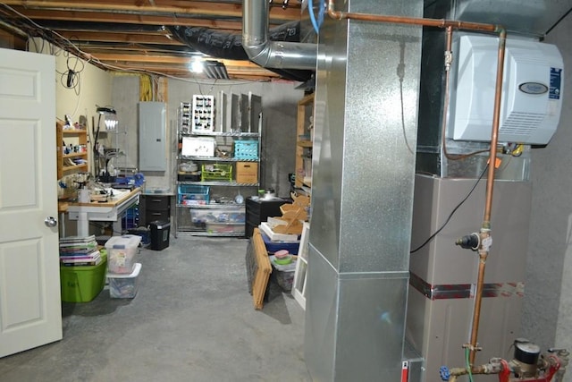 utility room with heating unit and electric panel