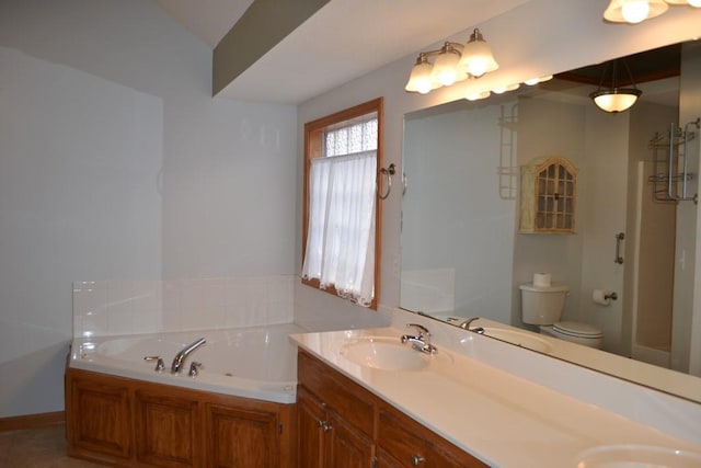 bathroom featuring vanity, a bath, and toilet