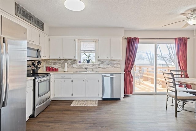 kitchen featuring appliances with stainless steel finishes, sink, and white cabinets