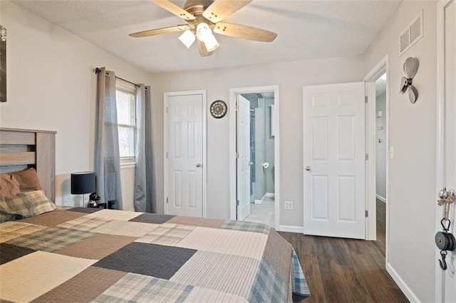 bedroom featuring dark hardwood / wood-style flooring, connected bathroom, a textured ceiling, and ceiling fan