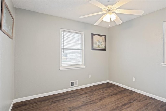 empty room featuring ceiling fan and dark hardwood / wood-style flooring