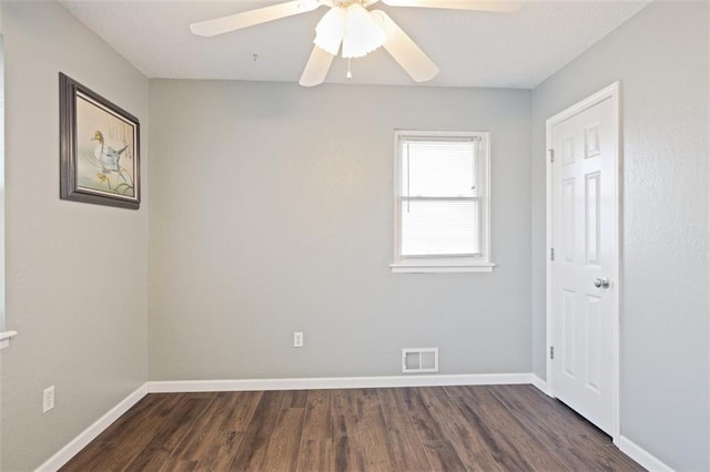 unfurnished room featuring dark hardwood / wood-style floors and ceiling fan