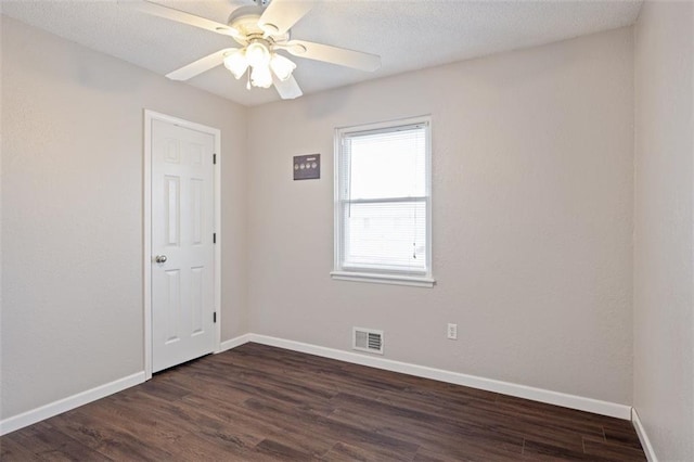 spare room featuring ceiling fan and dark hardwood / wood-style flooring