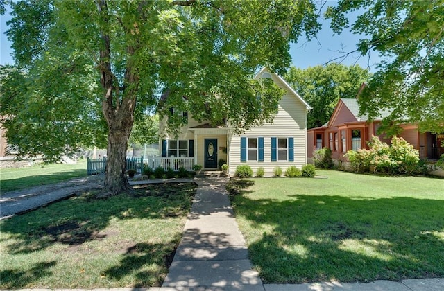 obstructed view of property featuring a front yard