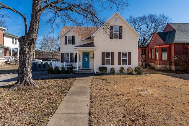 front facade with a front yard and a porch