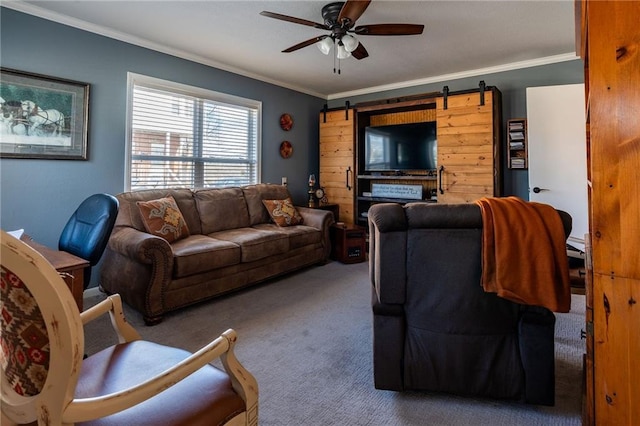 carpeted living room featuring crown molding, ceiling fan, and a barn door