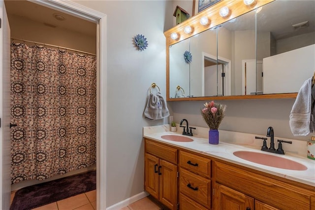 bathroom featuring tile patterned flooring and vanity