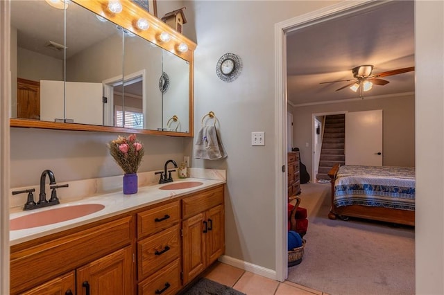 bathroom with tile patterned flooring, crown molding, vanity, and ceiling fan