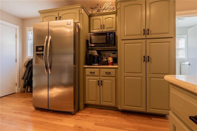 kitchen featuring stainless steel fridge with ice dispenser, light hardwood / wood-style flooring, and backsplash