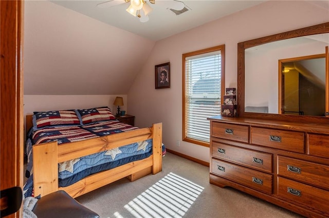 carpeted bedroom with vaulted ceiling and ceiling fan