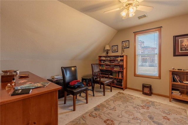 office area featuring vaulted ceiling, light colored carpet, and ceiling fan