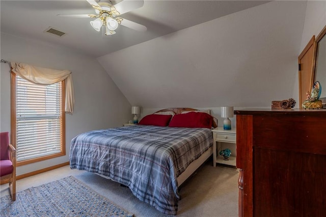 bedroom with lofted ceiling, light colored carpet, and ceiling fan