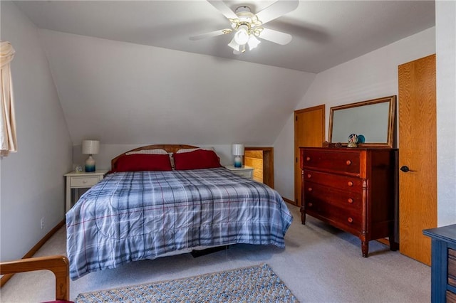 carpeted bedroom featuring ceiling fan and vaulted ceiling