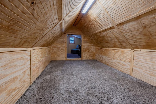 bonus room featuring lofted ceiling, wood ceiling, carpet floors, and wood walls