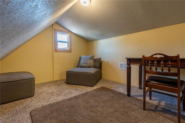 sitting room featuring vaulted ceiling, a textured ceiling, and carpet