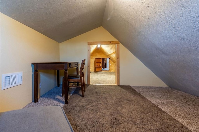 bonus room featuring lofted ceiling, carpet floors, and a textured ceiling