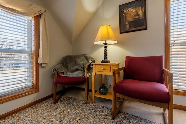 living area with vaulted ceiling and carpet flooring