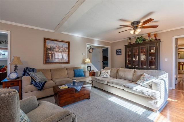 living room featuring ornamental molding, ceiling fan, and light hardwood / wood-style flooring