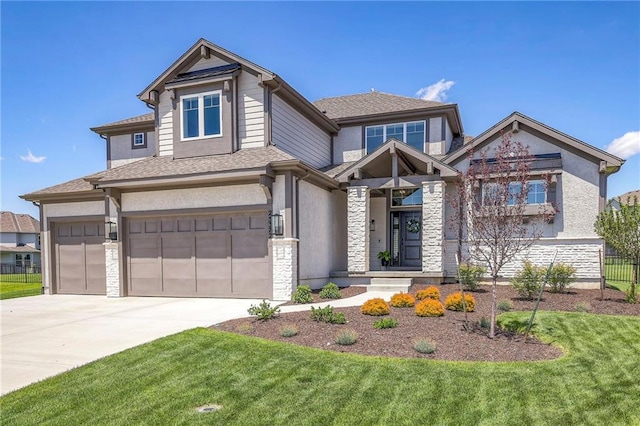 view of front of property featuring a front yard and a garage