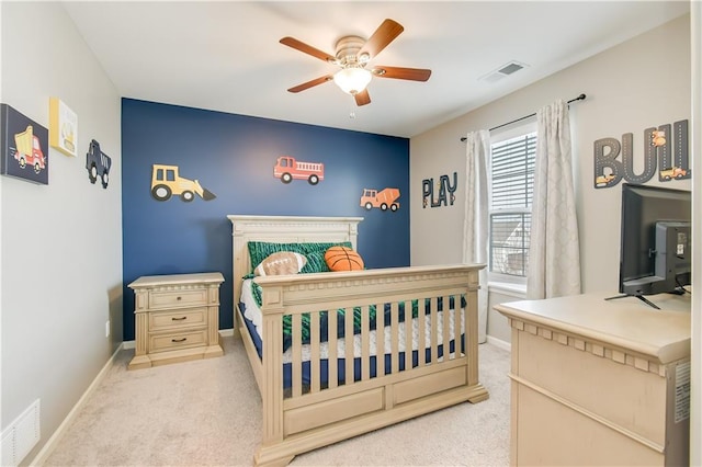 bedroom featuring light colored carpet and ceiling fan