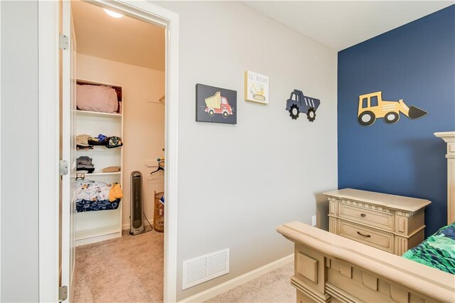 bedroom featuring light carpet