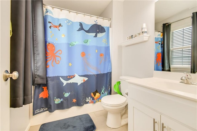 bathroom featuring tile patterned floors, vanity, and toilet