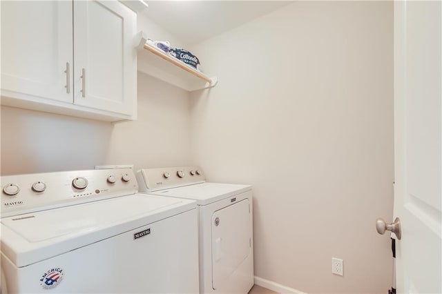 laundry area featuring cabinets and washer and clothes dryer