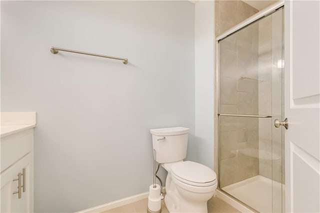 bathroom with tile patterned floors, vanity, toilet, and a shower with door