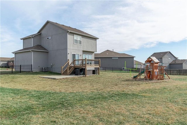 rear view of house featuring a playground and a lawn