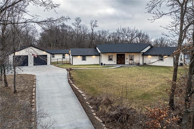 single story home with an outbuilding, a garage, and a front yard