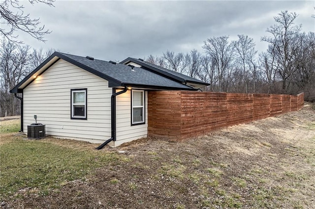 view of property exterior featuring cooling unit and a yard