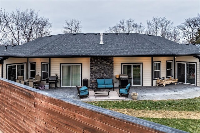 back of house featuring outdoor lounge area and a patio area