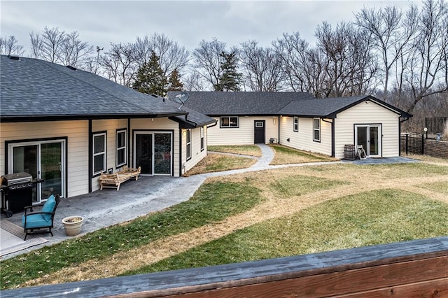 rear view of property with a patio area and a lawn