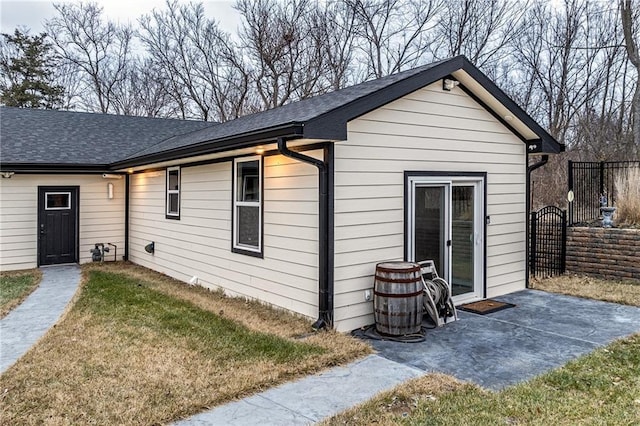 rear view of property featuring a lawn and a patio