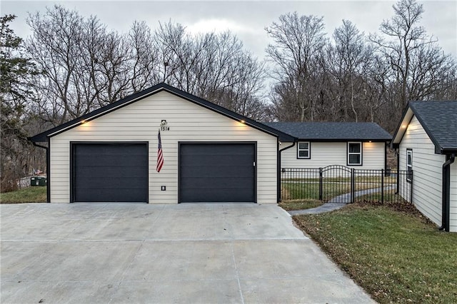 ranch-style home with a garage and a front lawn