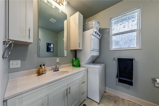 bathroom featuring stacked washer and dryer and vanity