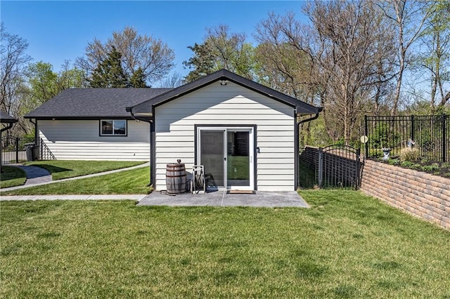 rear view of house with a patio area, a fenced backyard, and a yard