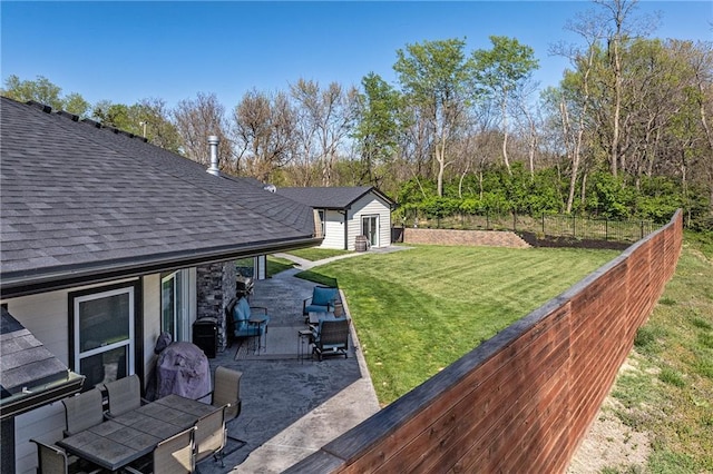 view of yard featuring a patio area, fence private yard, an outbuilding, and outdoor lounge area