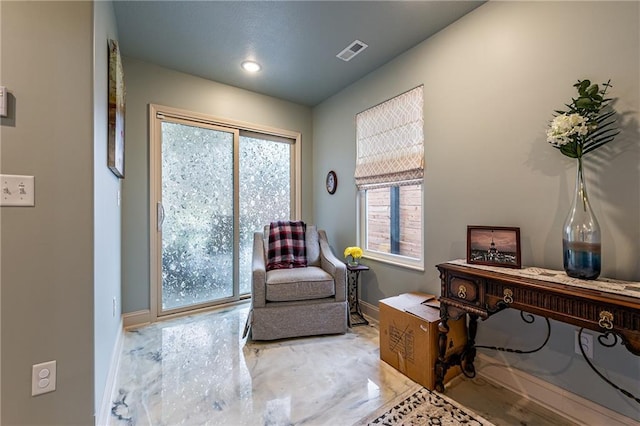 living area with baseboards, visible vents, and recessed lighting
