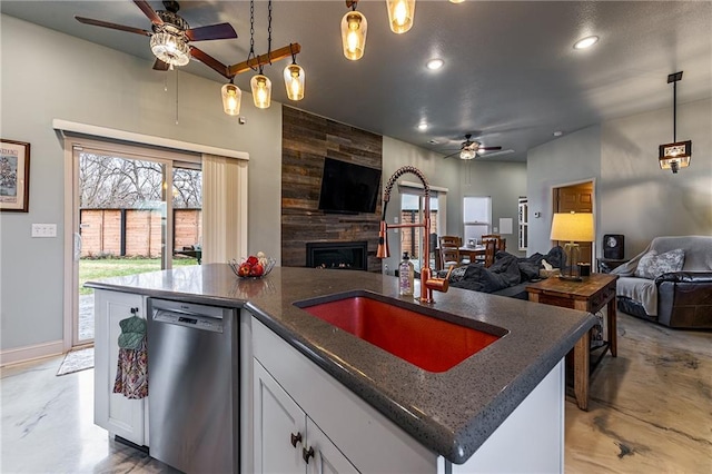 kitchen with concrete floors, open floor plan, a ceiling fan, and stainless steel dishwasher