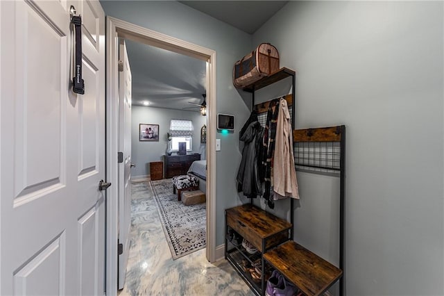 mudroom with marble finish floor, baseboards, and ceiling fan