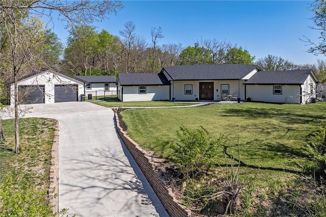 single story home featuring a front lawn, an outdoor structure, and aphalt driveway
