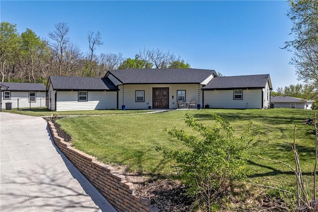 ranch-style home with fence and a front yard