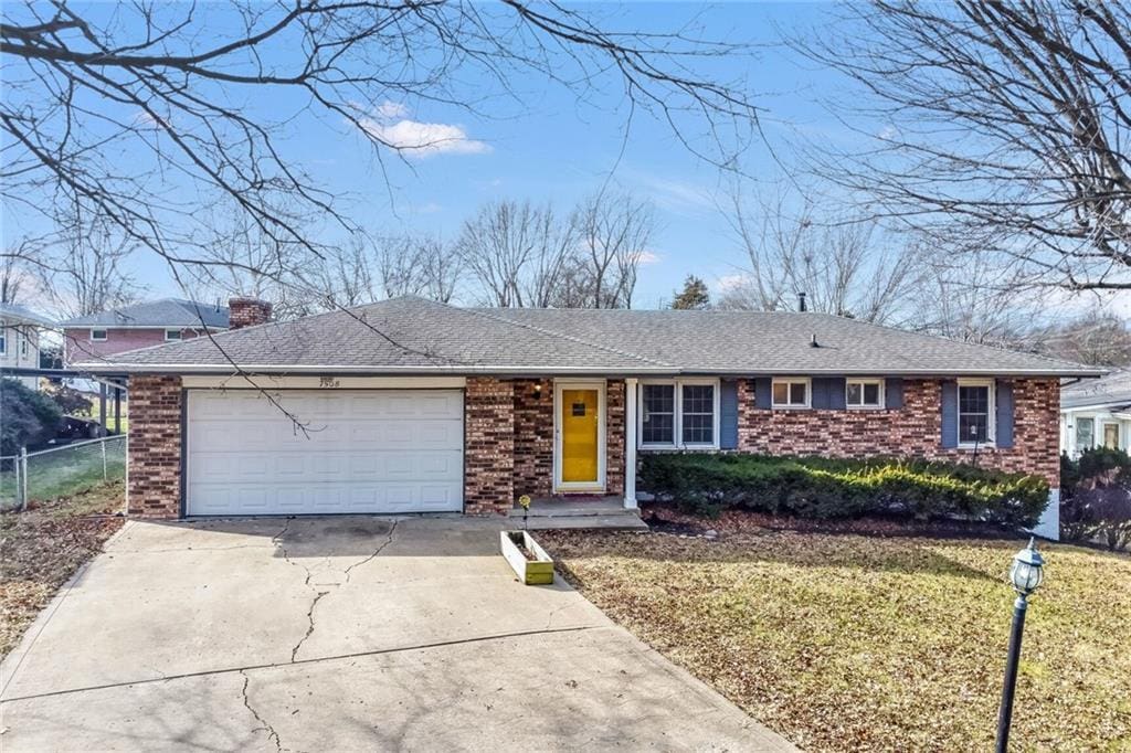 ranch-style home with a garage and a front yard