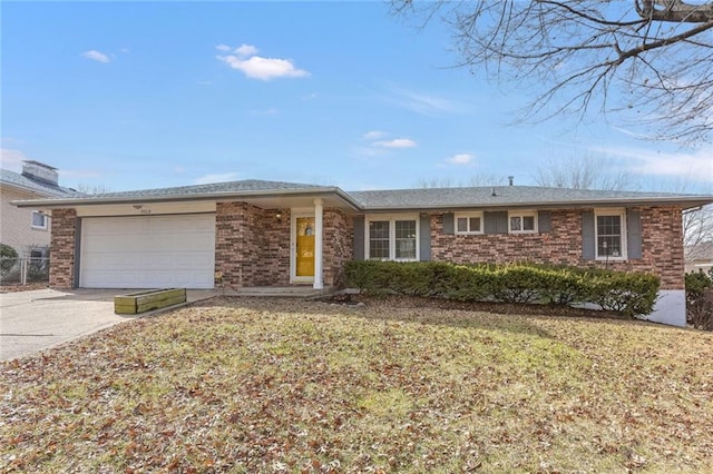 single story home with a garage and a front lawn