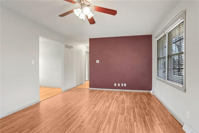 spare room featuring ceiling fan and light wood-type flooring